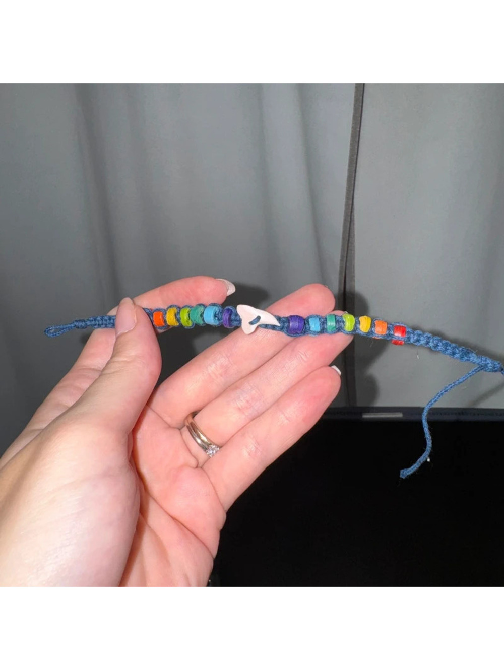 handmade macrame rainbow friendship bracelet featuring a focal shark tooth charm
